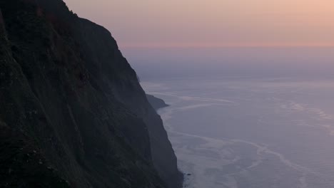 Sunset-cliff-seascape,-drone-establishing-shot