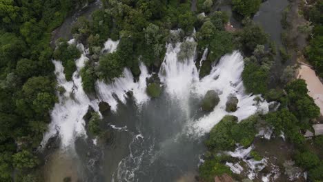 Full-summer-landscape-drone-view-of-Bosnia's-Kavica-waterfall,-a-mountain-landscape-with-many-water-streams