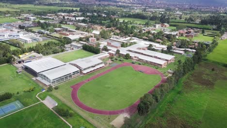 Aerial-Drone-Shot-of-Sports-Stadium-with-Athletics-Running-Track