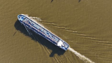 Birdseye-view,-tanker-on-river-unfolds-as-powerful-yet-graceful-vessel