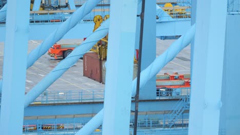 Hydraulic-lifts-carefully-transferring-goods-at-shipping-port-terminal