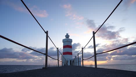 A-view-of-the-walkway-towards-a-striking-lighthouse-in-Iceland-just-before-sunset