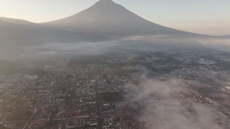 Wide-view-of-Antigua-city-at-Guatemala-during-foggy-morning,-aerial