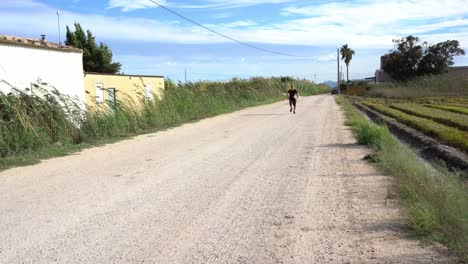 Person-running-and-doing-sports-on-a-dirt-road