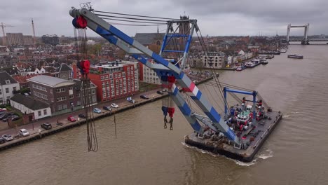 Industry-Crane-mechanical-arm-extends-with-precision-as-it-sails-along-river