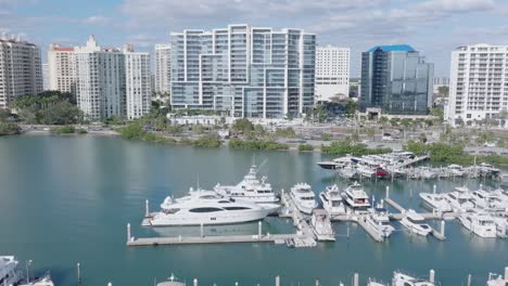 Glide-towards-a-stunning-Sarasota-hotel-and-over-a-marina-with-boats-in-a-cinematic-forward-dolly-shot