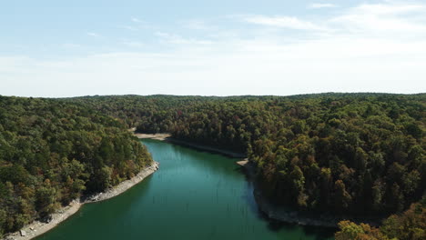 Eagle-hollow-cave-in-Beaver-lake,-Arkansas,-aerial-flying-over-water,-fall