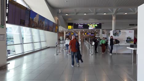 Travelers-walking-among-ribbon-barrier-to-the-international-check-in-gate-at-Brussels-Airport-in-Zaventem,-Belgium