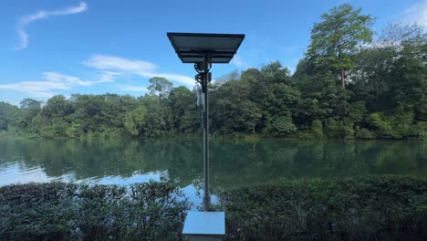 Surveillance-cameras-powered-by-solar-panels-against-the-background-of-the-scenic-view-of-Macritchie-Reservoir-in-Singapore