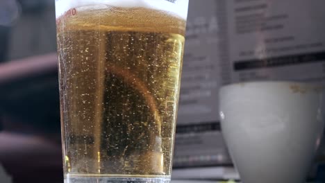 Slow-Motion-Beer-bubbles-in-a-glass-on-a-bar-table