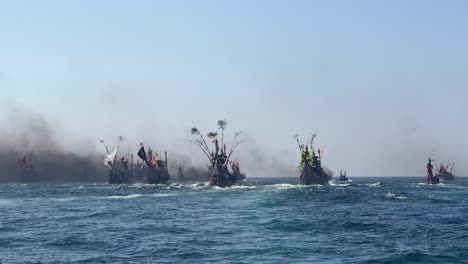 Bug-number-of-fishing-boats-in-Indian-Ocean-during-Patik-Laut-festival-in-Muncar,-Banyuwangi,-Jawa,-Indonesia-covered-in-smoke-exhaust