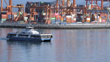 SeaBus---Passenger-Only-Ferry-Service-With-Container-Port-In-The-Background-In-Coal-Harbour,-Canada