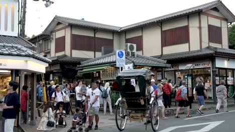 Busy-Street-Scene-With-Rickshaw-And-Tourists-On-Path-Leading-To-Arashiyama-Bamboo-Forest