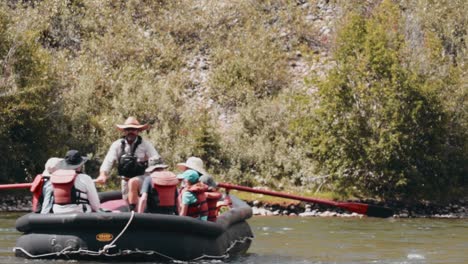 Slow-motion-of-group-of-people-rafting-down-the-river-with-guide