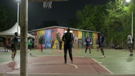 Team-of-black-friends-playing-basketball-at-night-in-aftica