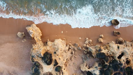 Drone-aerial-bird's-eye-landscape-scenic-rocky-headland-coastline-sandy-beach-shore-waves-nature-travel-tourism-Praia-Portugal-Europe-4K