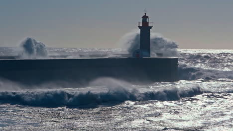 Cinematic-capture-of-big-waves-splashing-near-Felgueiras-Lighthouse,-situated-in-Porto,-Portugal,-stands-as-a-beacon-of-maritime-heritage-and-coastal-charm
