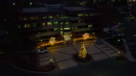 Aerial-approaching-shot-of-High-Office-Building-in-Pennsylvania-with-lighting-Christmas-decoration-outdoors-at-night
