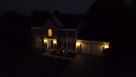 American-Colonial-two-story-home-at-night-with-garage-and-front-porch-lights-on
