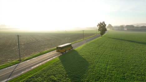 School-bus-drives-on-rural-country-road-on-bright-sunny-morning