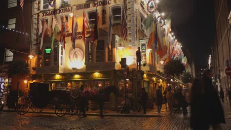 Tilt-shot-of-the-corner-of-the-oliver-pub-during-nighttime-in-Dublin-Ireland