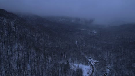 Beautiful-aerial-drone-time-lapse-nightfall-footage-of-the-Appalachian-Mountains-covered-in-snow-at-night-during-evening