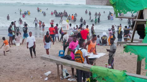 african-people-gathering-at-sunset-in-Sakumono-beach-on-the-coastline-of-west-africa-established-shot