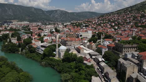 Drone-view-of-the-historical-architecture-of-Mostar-Bridge,-view-of-the-mosque-in-the-city-with-Ottoman-architecture