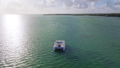 Aerial-drone-view-of-Catamaran-sailing-offshore-on-a-tropical-ocean