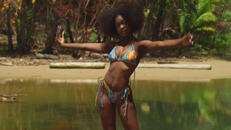 A-bikini-clad-girl-with-curly-hair-relishes-the-beauty-of-a-sunny-day-on-a-tropical-Caribbean-island-beach