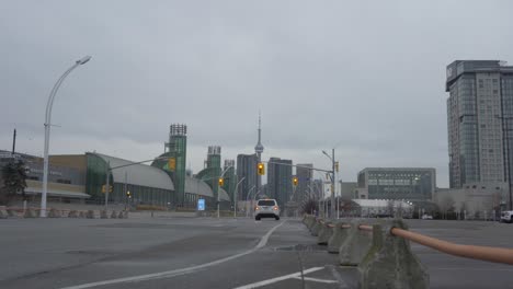 Car-passing-barrier-in-street-road-stoplight-barrier-transport-city-skyline-tower-buildings-Toronto-Ontario-Canada