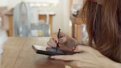 Woman-hand-using-digital-stylus-pen-with-smartphone