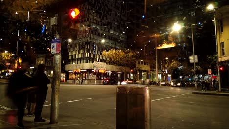 Tilt-motion-lapse-of-Melbourne-CBD-busy-crossing-at-night