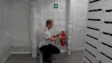 Ships-Captain-is-showing-fire-extinguisher-in-ships-engine-and-battery-room