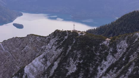 People-enjoying-the-view,-summit-cross-of-Herzogstand-mountain
