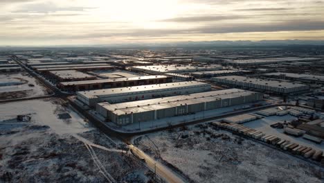 Giant-warehouses-covered-with-snow-in-the-middle-of-winter-with-the-Rocky-Mountains-in-the-background