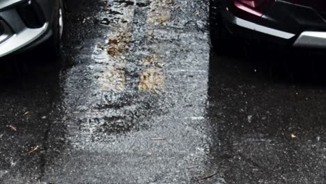 Heavy-torrential-rainfall-splashing-and-bouncing-off-asphalt-ground