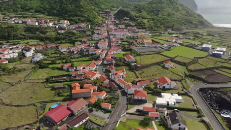Panoramic-view-of-Fajã-Grande-coastal-town-at-Flores-island-Azores---Drone-shot