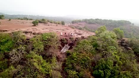 A-group-of-cyclists-overlooking-the-cliff-at-Vagator,-Goa