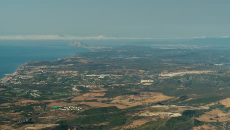 Gibraltar-rock-in-far-distance-with-panoramic-view-of-Spain-flatland,-time-lapse