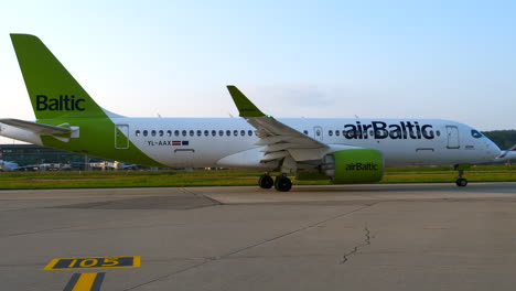 Airplane-of-Air-Baltic-Airlines-in-moving-on-runway,-transportation-scene