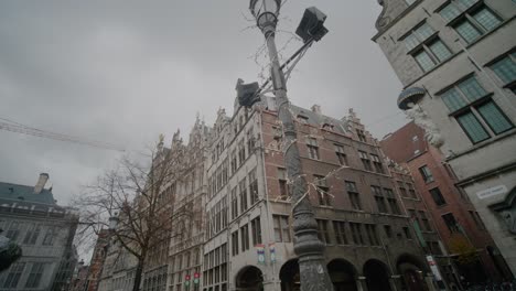 Street-Corner-Antwerp,-Tall-Buildings,-Street-Lamp-Festive-Lights,-Day