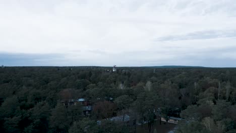 Moody-drone-video-of-a-tower-in-the-forest-and-a-beautiful-cloudy-sky-in-Brandenburg,-germany