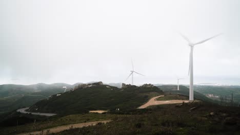 Power-turbines-spin-on-mountains-in-Spain,-static-view