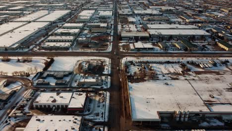 Aerial-revealing-shot-of-an-endless-warehouse-area-in-Calgary-in-winter