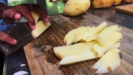 Closeup-of-hand-with-knife-cutting-fresh-potato