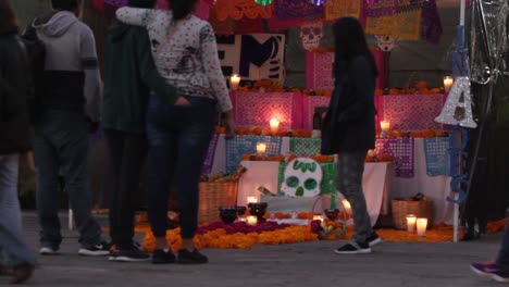 A-timelapse-of-people-walking-watching-the-altars-during-the-day-of-the-dead,-which-is-one-of-the-most-popular-holidays-in-mexico