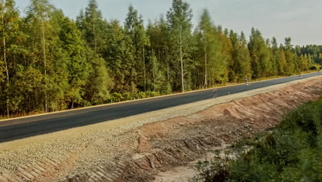 Building-of-concrete-cement-road-over-dirt-road-in-forest-time-lapse