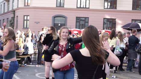 Young-festival-and-party-goers-enjoy-life-at-an-open-air-street-party-dancing-together-united-as-friends