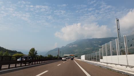 Driving-towards-Lake-Garda-close-to-the-city-of-Rovereto,-in-Northern-Italy,-on-a-cloudy-autumn-day